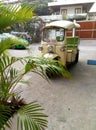 Three-wheeled mototaxi with a roof stands in the yard