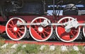 Three wheels and coupling devices of a big old steam locomotive Royalty Free Stock Photo