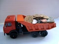 Three wheelset axled dump-truck loaded by coins Royalty Free Stock Photo