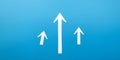 Three white arrows pointing upwards on a blue background Royalty Free Stock Photo