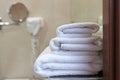 Three white bath towels are stacked on a bathroom shelf. Side view. Hotel business concept Royalty Free Stock Photo