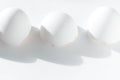 Three white broken eggshells on a white background Royalty Free Stock Photo