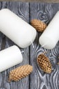 Three white candles lie on painted pine boards. Spruce cones are spread out nearby Royalty Free Stock Photo