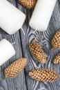 Three white candles lie on painted pine boards. Spruce cones are spread out nearby Royalty Free Stock Photo