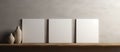 Three white canvases displayed on a hardwood shelf near vases Royalty Free Stock Photo