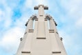 White religious cross with blue sky background