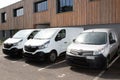 Three White Delivery Trucks vans Backed Up to Warehouse Building Royalty Free Stock Photo