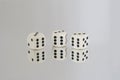 Three White dice with Black spots and reflections Royalty Free Stock Photo
