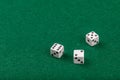Three White Dice on Green Velvet Casino Table for Gaming and Gambling Royalty Free Stock Photo
