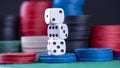 Three white dice are stacked on top of each other in front of a pile Royalty Free Stock Photo