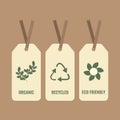 Three white eco tags with green branch, recycle icon, and flower. Vector illustration. Royalty Free Stock Photo