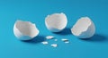 Minimalist Broken Eggshells on Vibrant Blue Background Royalty Free Stock Photo