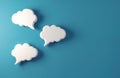 Three white empty speech bubbles float on blue background. They are ready for text. Graphic element for communication ideas and Royalty Free Stock Photo