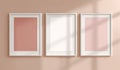 Triptych of White Picture Frames with Pastel Inserts on a Textured Wall Royalty Free Stock Photo
