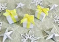 Three White gift boxes tied with yellow ribbon on grey marble background with star and snowflake origami . Royalty Free Stock Photo