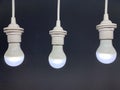 Three white lamps turned on over black background Royalty Free Stock Photo