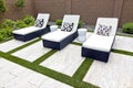 Three White Lounge Chairs On Black Wicker Bases