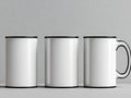 Three white mugs with black handles on a gray background Royalty Free Stock Photo