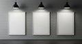 Three white picture frames on grey brick wall under spotlights Royalty Free Stock Photo