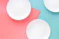 Three white plates on color background.