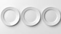 Three empty white ceramic dinner plates arranged in a row on a clean white background Royalty Free Stock Photo