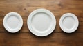 Three White Empty Plates on a Wooden Table - Top View Royalty Free Stock Photo