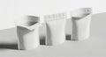Three white pouches lined up on a light gray surface with shadows Royalty Free Stock Photo