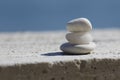 Three white pyramid of stones for meditation lying on sea coast Royalty Free Stock Photo