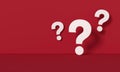 Three white question marks in front of a red wall background Royalty Free Stock Photo