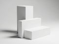 Three white rectangular blocks arranged in a descending size order on a plain background Royalty Free Stock Photo