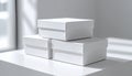 Three white rectangular boxes stacked on top of each other on a white table Royalty Free Stock Photo