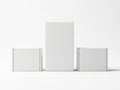 Three white rectangular boxes of different sizes on a plain white background with minimal shadow isolated on white background Royalty Free Stock Photo