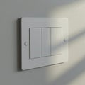 Three white, rectangular light switches are set into a wall with a matching white plate Royalty Free Stock Photo
