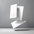 Three white rectangular papers floating in the air against a gray background in a studio setup scene Royalty Free Stock Photo