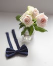 Three white roses and bow tie. White background Royalty Free Stock Photo