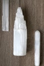 Three White Selenite Crystals on Wood background