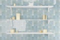 Three white shelves on the wall with blue tiles and abstract golden geometric objects.