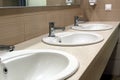 Three white sinks in the toilet room Royalty Free Stock Photo