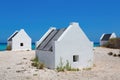 Three white slave houses on beach near sea Royalty Free Stock Photo