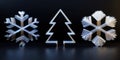 Three white snowflakes lined up on a black surface with sharp contrast and detailed patterns. Royalty Free Stock Photo