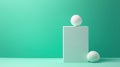 Three white spheres of varying sizes are arranged on a white cube against a teal background. Royalty Free Stock Photo