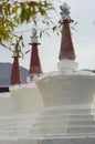 Three white stupas in a temple in India