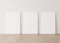 Minimal frame mock up interior, Three white vertical frames Standing on parquet floor