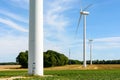 Three wind turbines lined up amid the fields Royalty Free Stock Photo