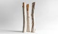 Three white wooden sticks are standing upright on a white surface Royalty Free Stock Photo