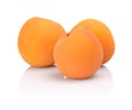 Three whole apricots on white