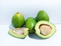 Three whole Avocado, 2 half avocado on white Background, fruit nature nutritio Royalty Free Stock Photo