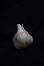 Three whole garlic bulbs grouped on black stone plate Royalty Free Stock Photo