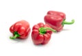 Three whole red ripe bell peppers isolated on white background close up Royalty Free Stock Photo