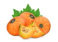 Three whole and slice pumpkin with green leaves